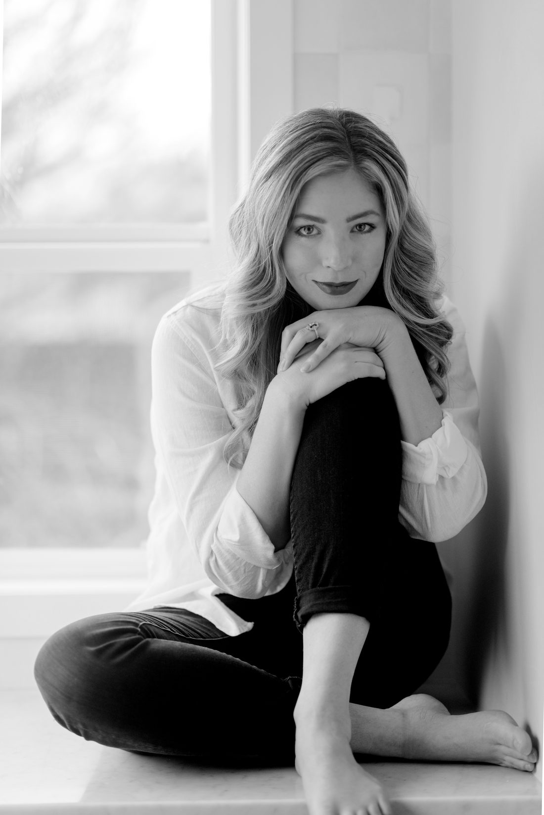 McKenna, seated in the window light of her studio